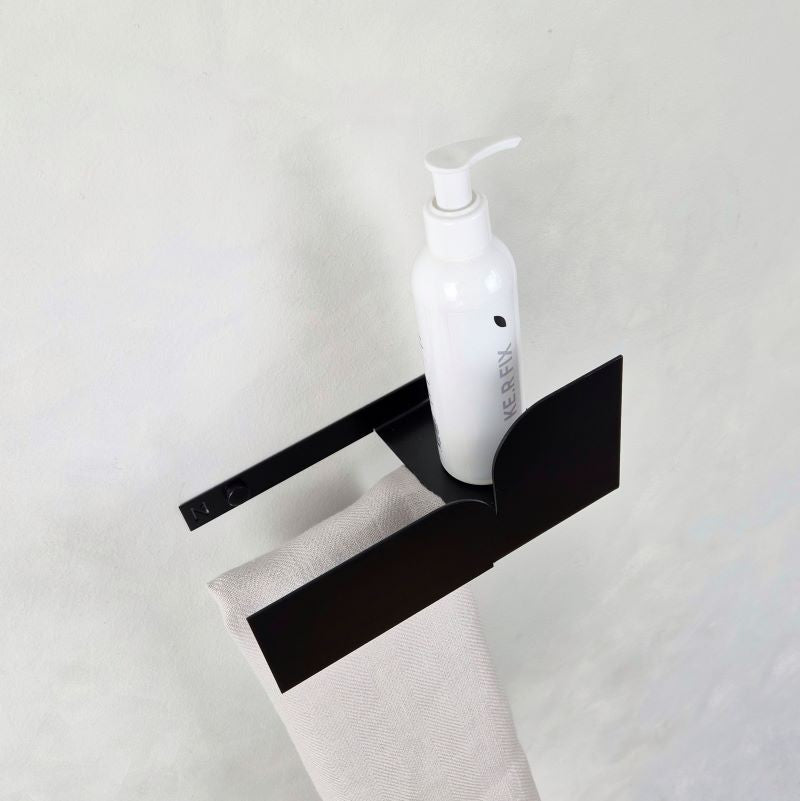 Black hand towel holder with a shelf