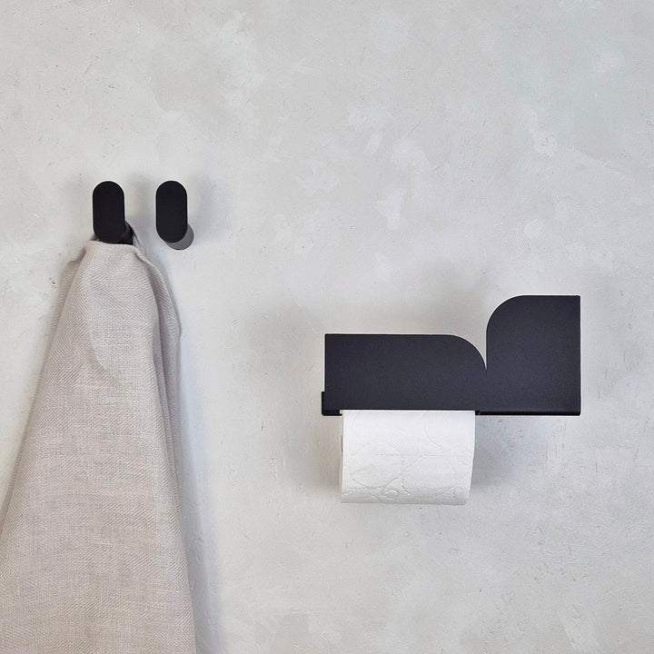 Minimalist wall hook in modern Scandinavian design, featuring clean lines and a towel holder.