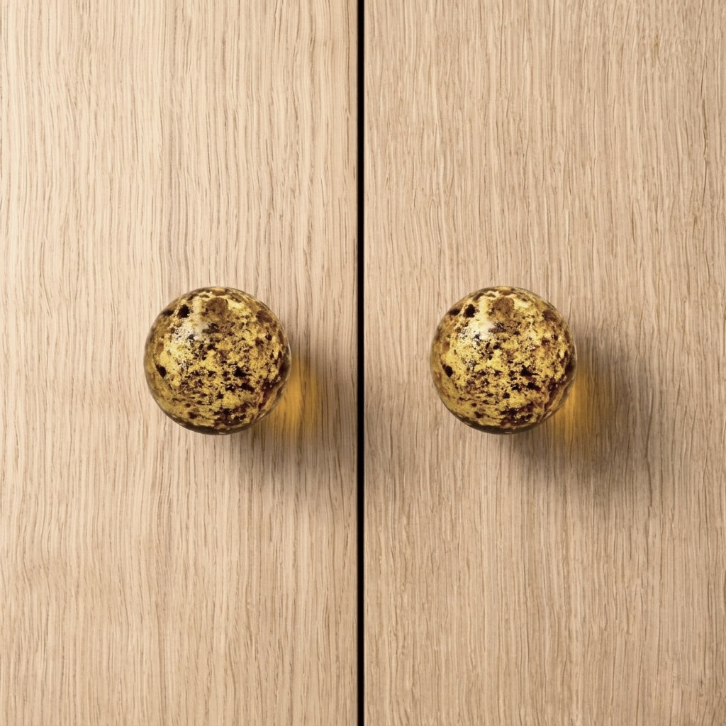 Round knob AMBER on wooden cabinet doors, showcasing modern design and sophistication.