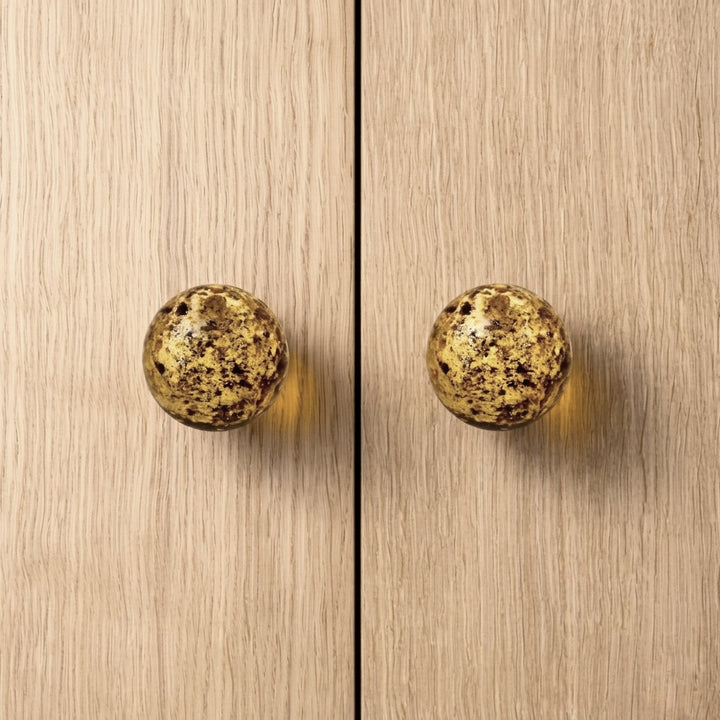 Round knob AMBER on wooden cabinet doors, showcasing modern design and sophistication.