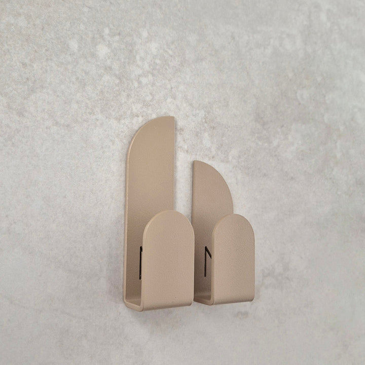 Adhesive wall hooks in a clean geometric design, ideal for organizing essentials in any room.