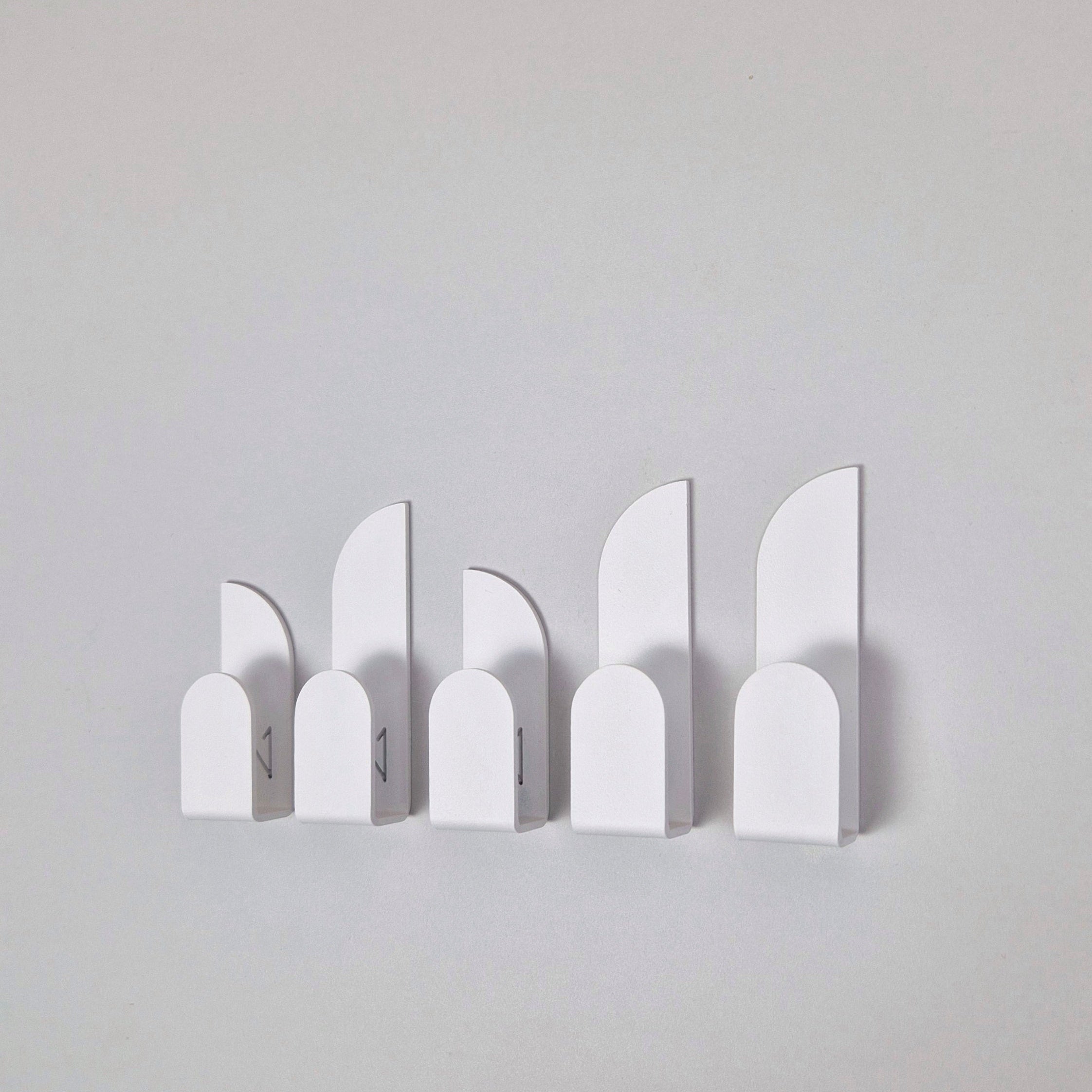 Adhesive wall hooks BAUHAUS in a minimalist design, perfect for home organization and stylish storage solutions.