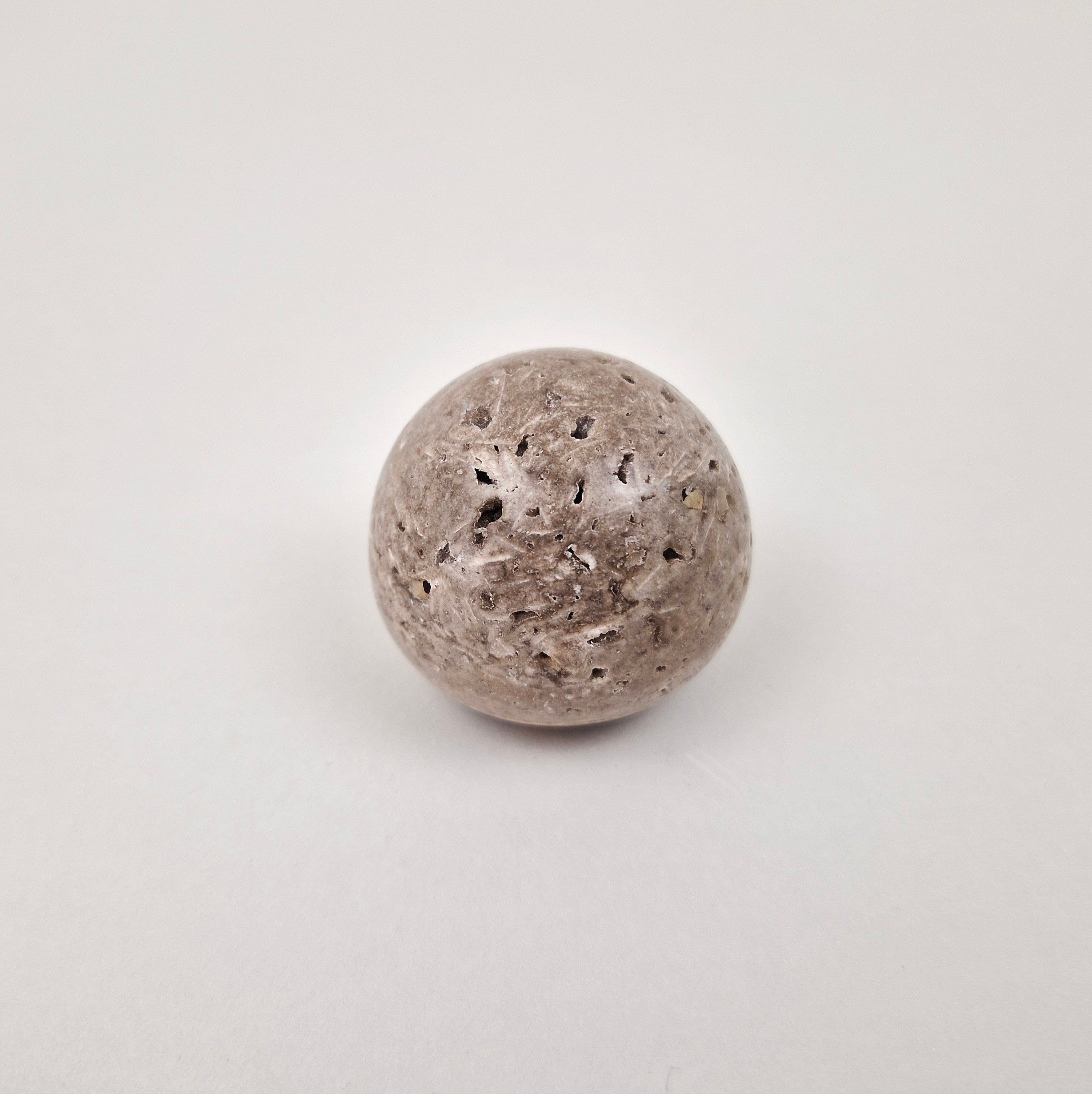 Natural stone cabinet knob made from travertine showcasing unique textures and earthy elegance.