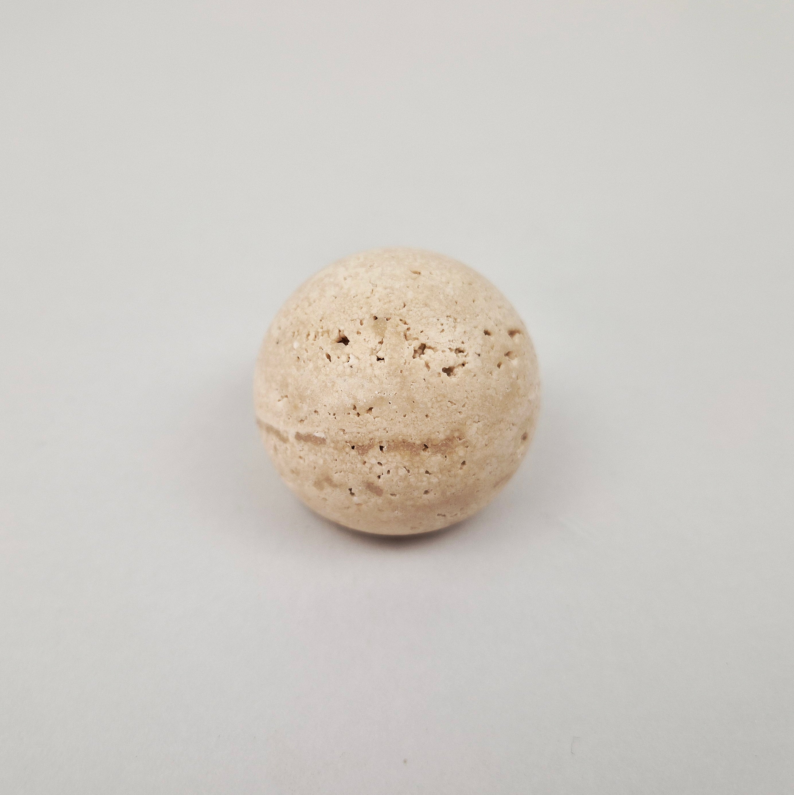 Natural travertine stone cabinet knob featuring unique veining and textures.