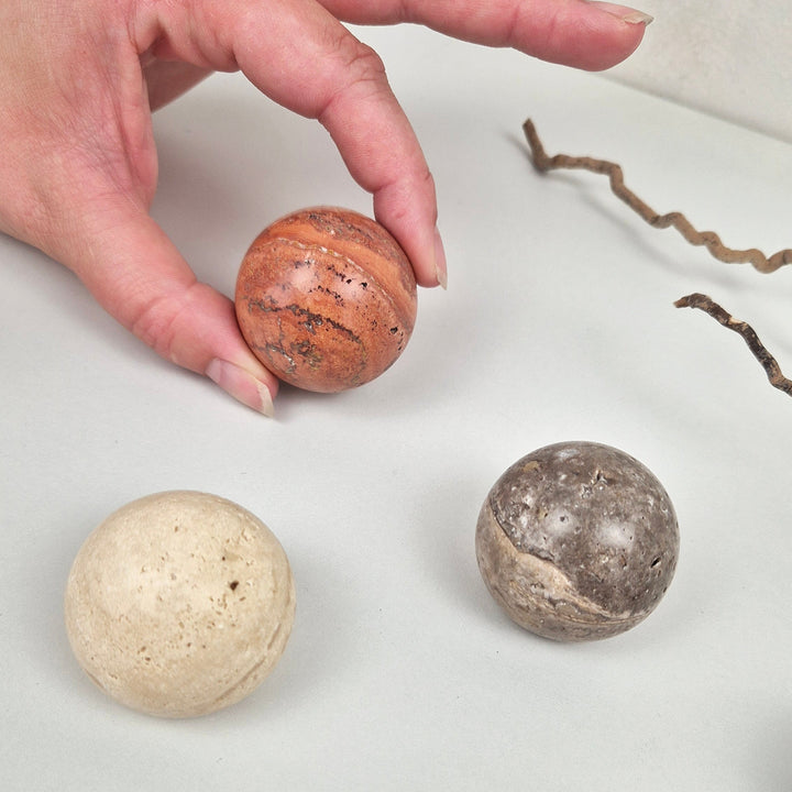 Natural stone balls showcasing unique textures, perfect for stone cabinet knob design inspiration.