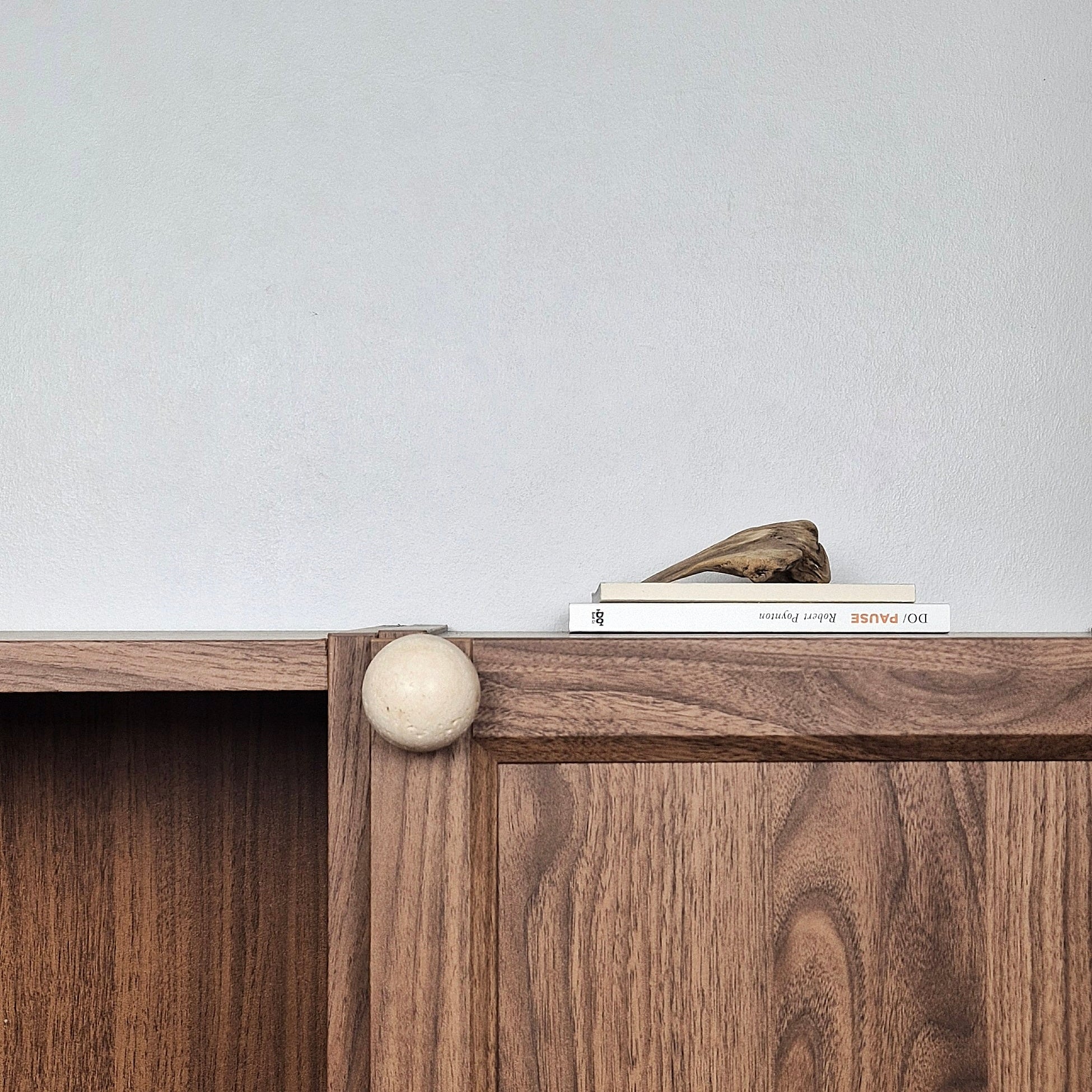 Natural stone cabinet knob on a wooden cabinet, showcasing its unique design and texture.