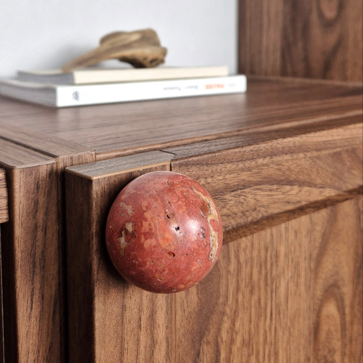 Natural stone cabinet knob on wooden cabinet showcasing unique veining and earthy elegance.