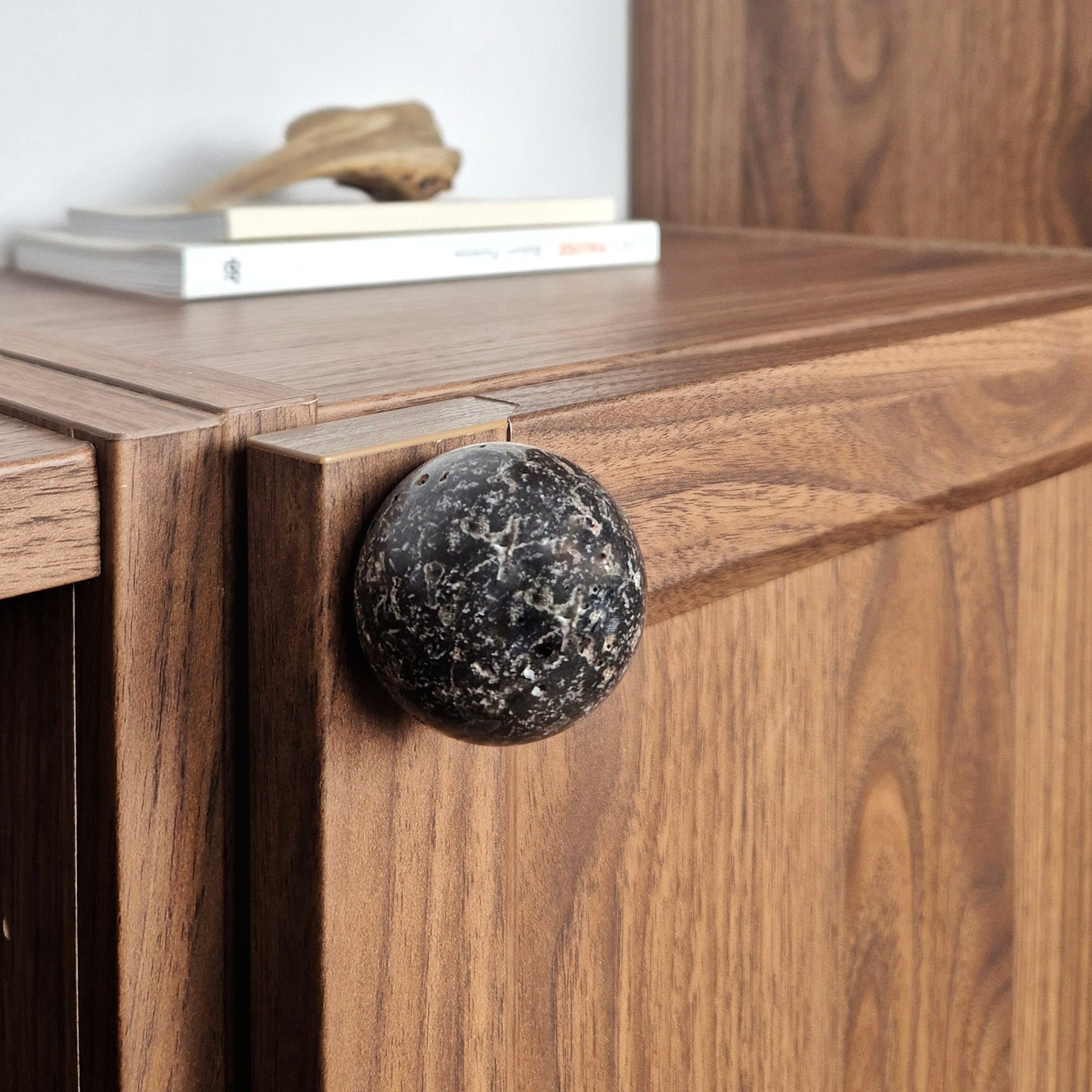 Stone cabinet knob installed on a wooden cabinet, showcasing natural stone texture and modern design.