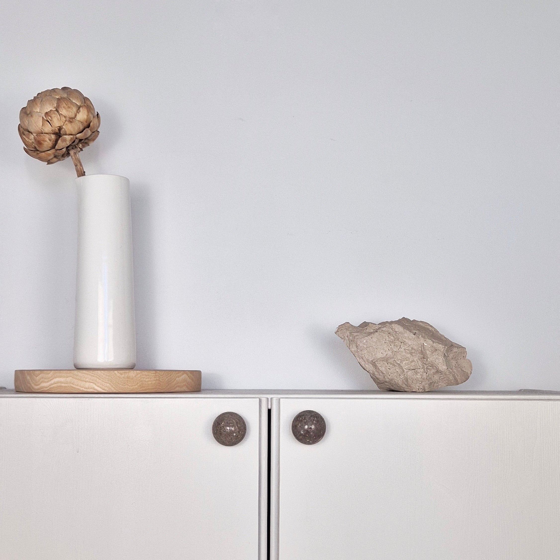 Natural Stone Cabinet Knob on modern cabinet with vase and decorative stone, showcasing stone cabinet knob design.