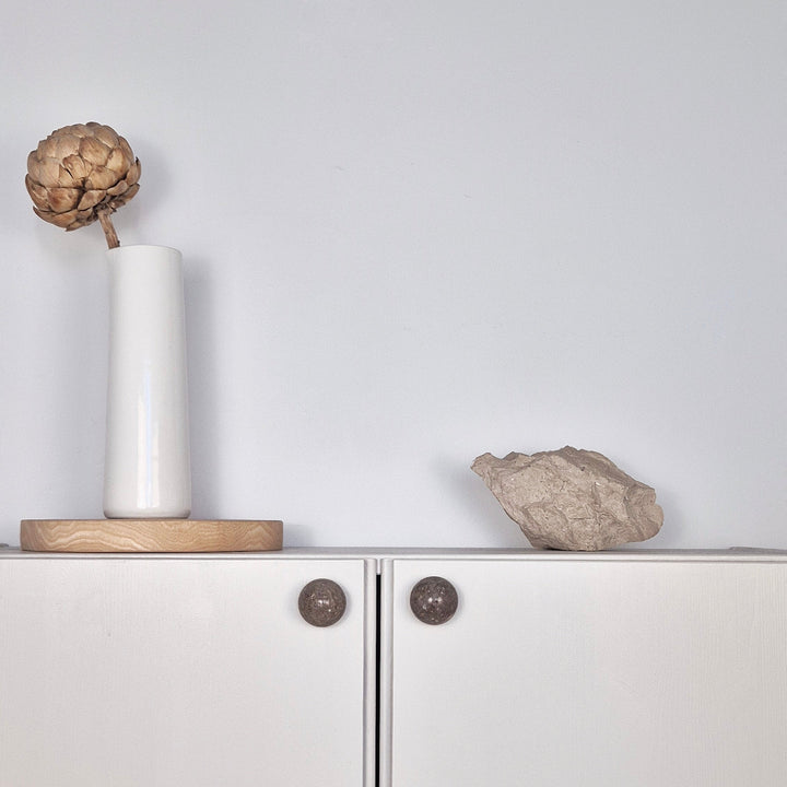 Natural Stone Cabinet Knob on modern cabinet with vase and decorative stone, showcasing stone cabinet knob design.