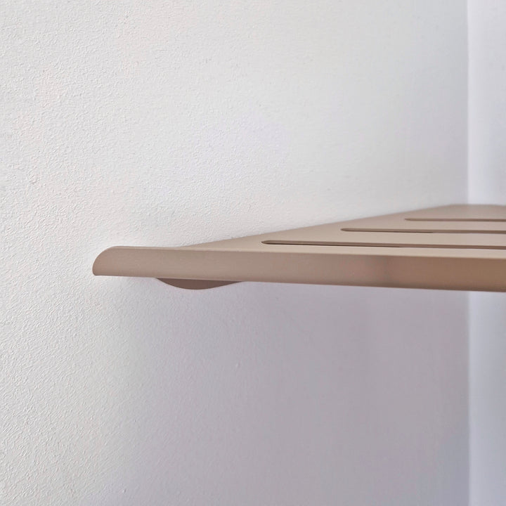 Beige shower corner shelf with clean lines and matte finish, designed for minimalist shower storage.