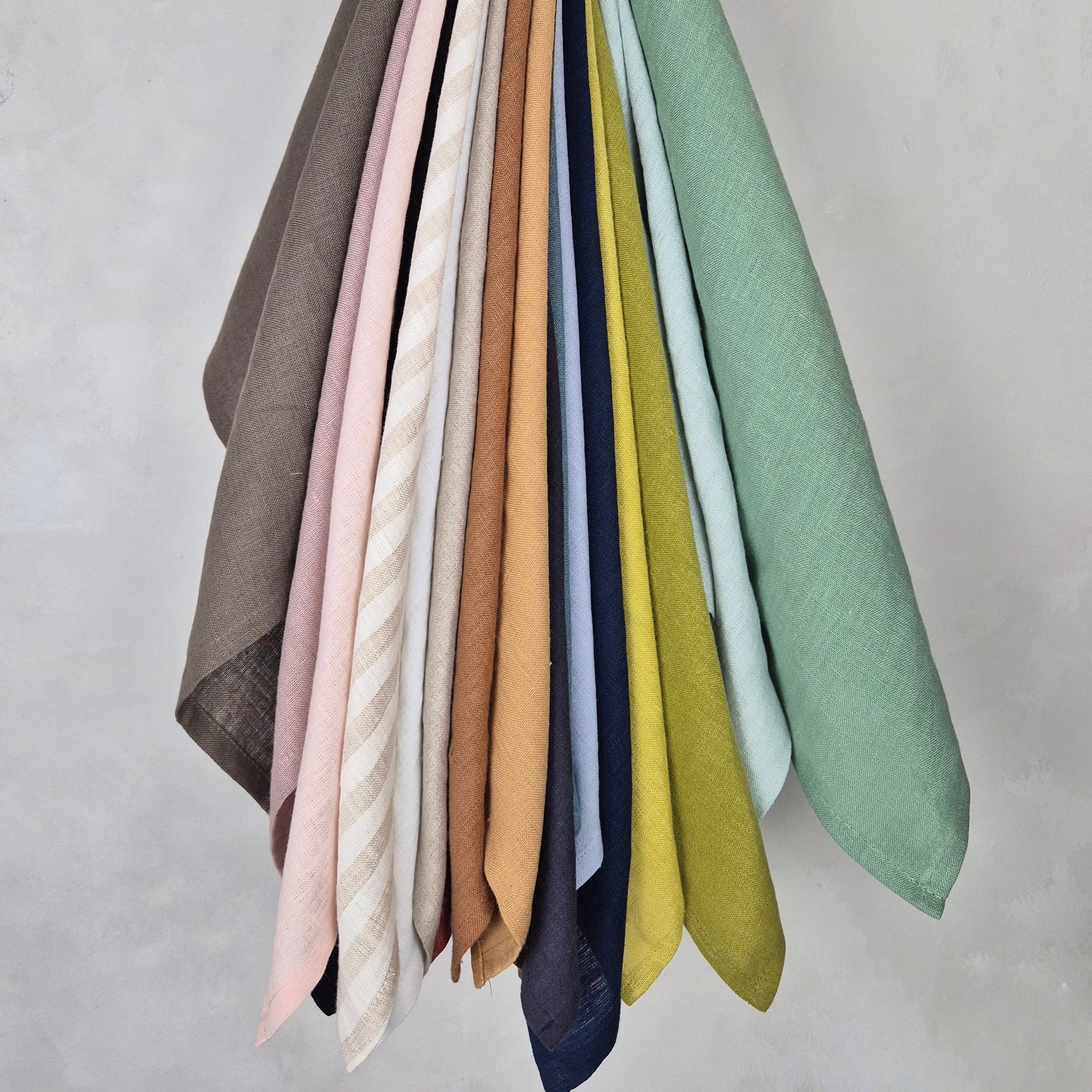 Linen napkin collection showcasing various colors, perfect for elegant dining or casual breakfasts.