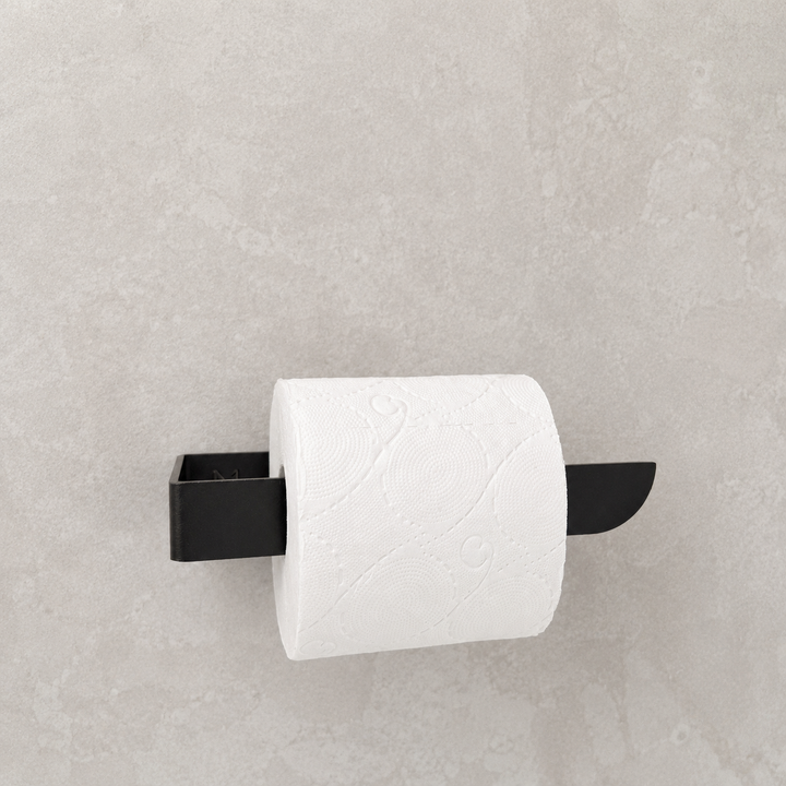 Black toilet paper holder mounted on a light gray wall, holding a roll of white paper towels.