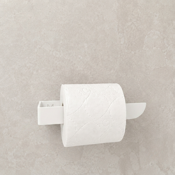 Adhesive white toilet paper holder mounted on a light gray wall with white paper roll.