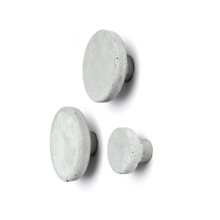 Set of three light grey concrete wall hooks, perfect for storage and decoration. Concrete wall hook for various uses.