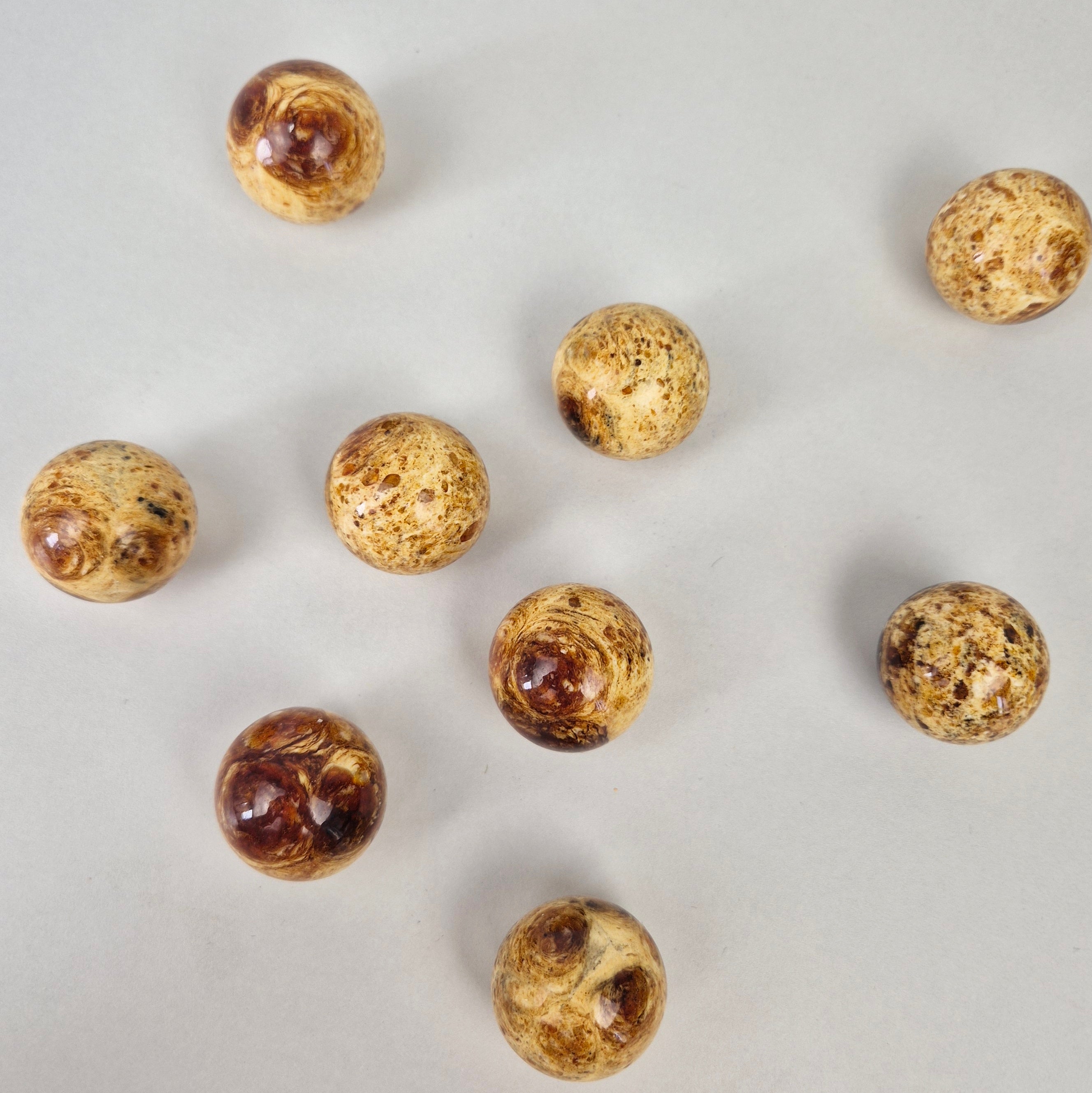Round amber knob collection featuring beautifully crafted knobs with a modern design and pressed amber finish.